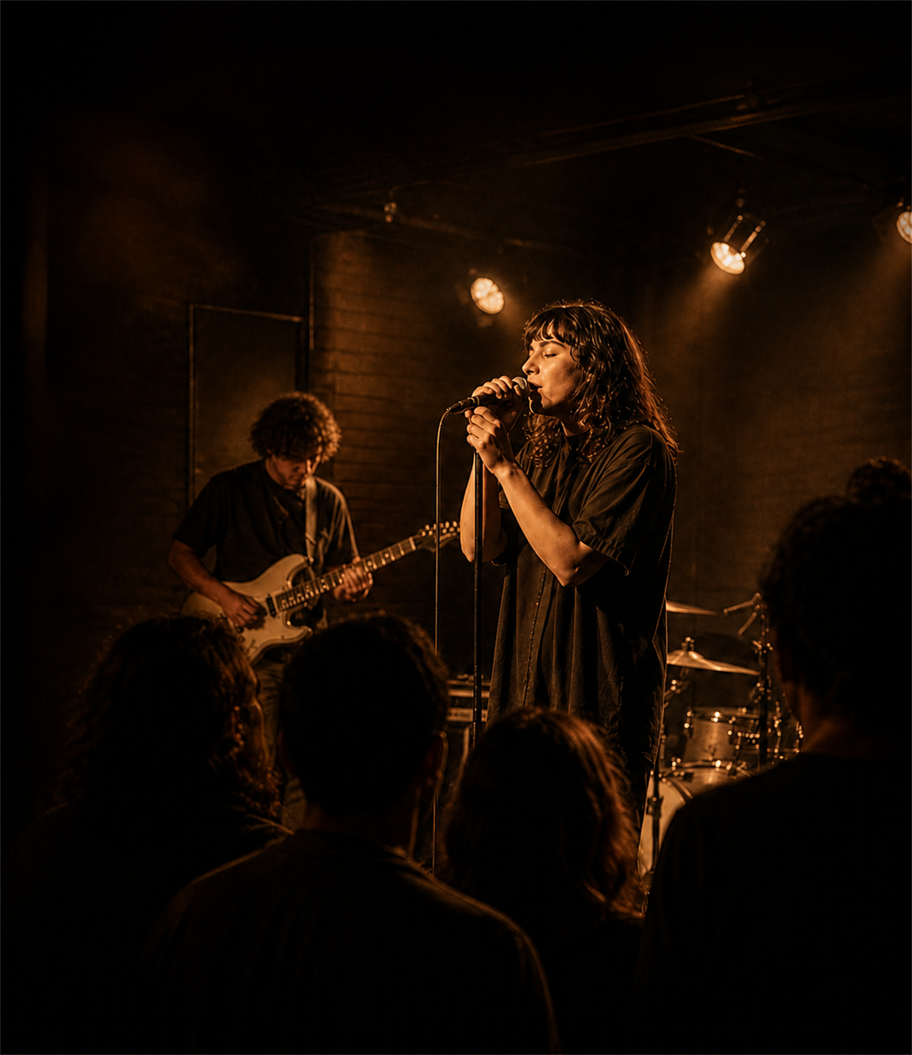 Singer in an intimate amber-lit venue.